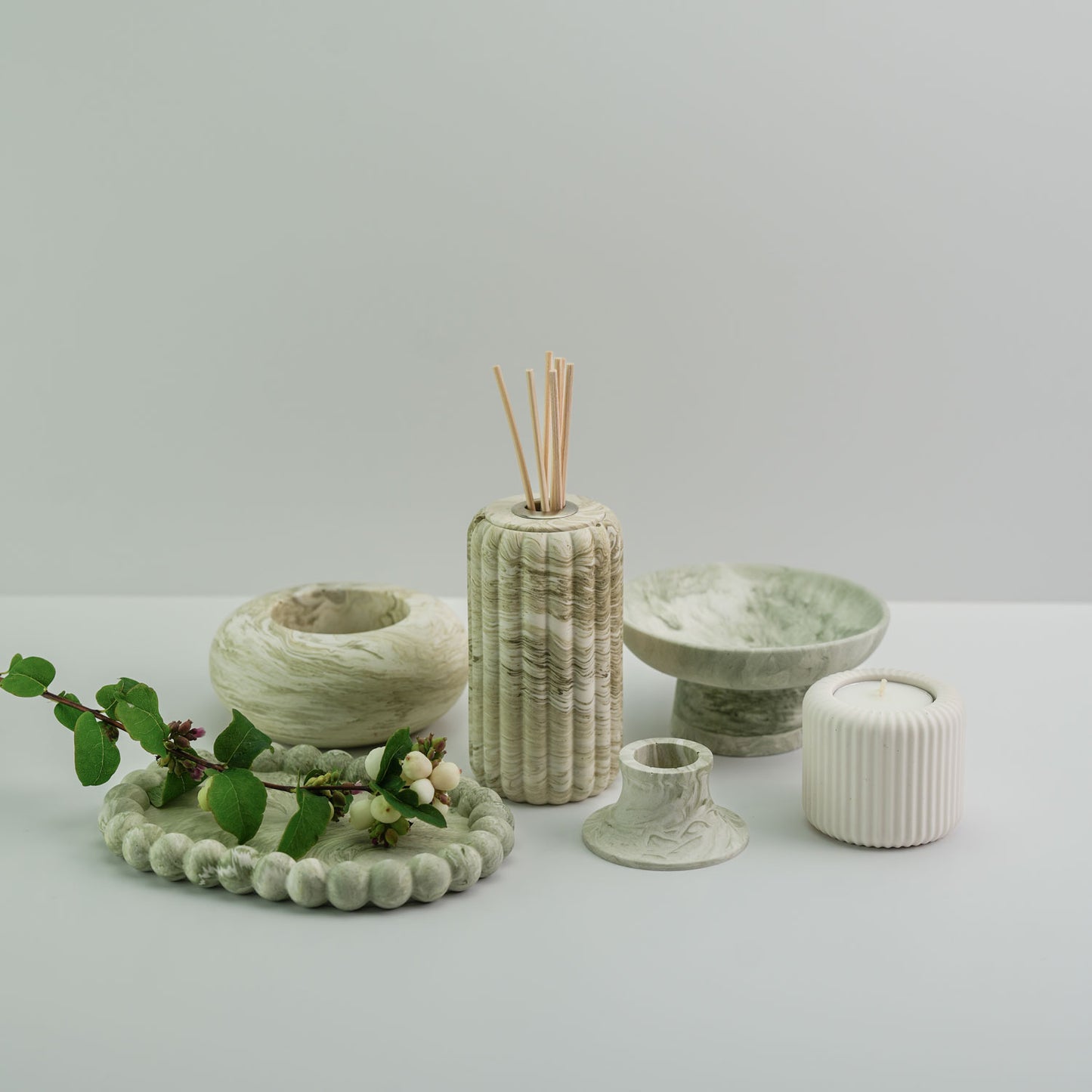 A display of jesmonite home decore items, including defuser