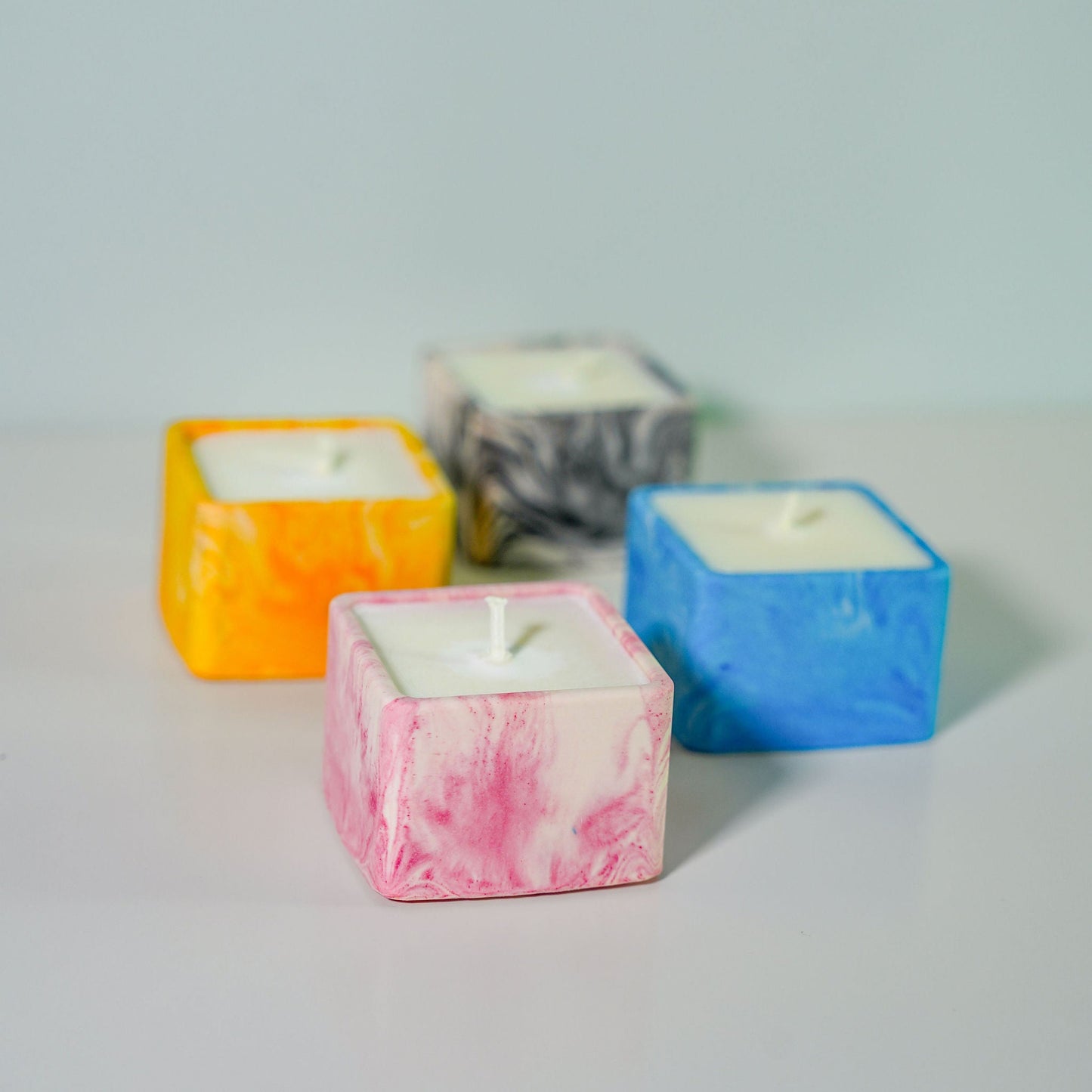 A selection of jesmonite candle holders in various colours