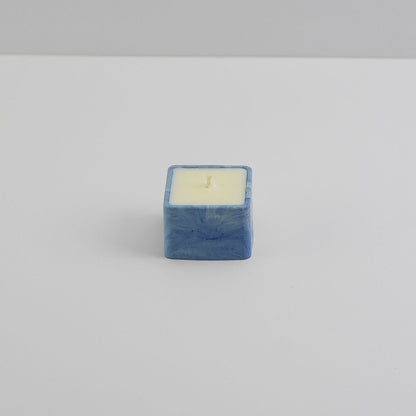 A small, square jesmonite candle holder in blue