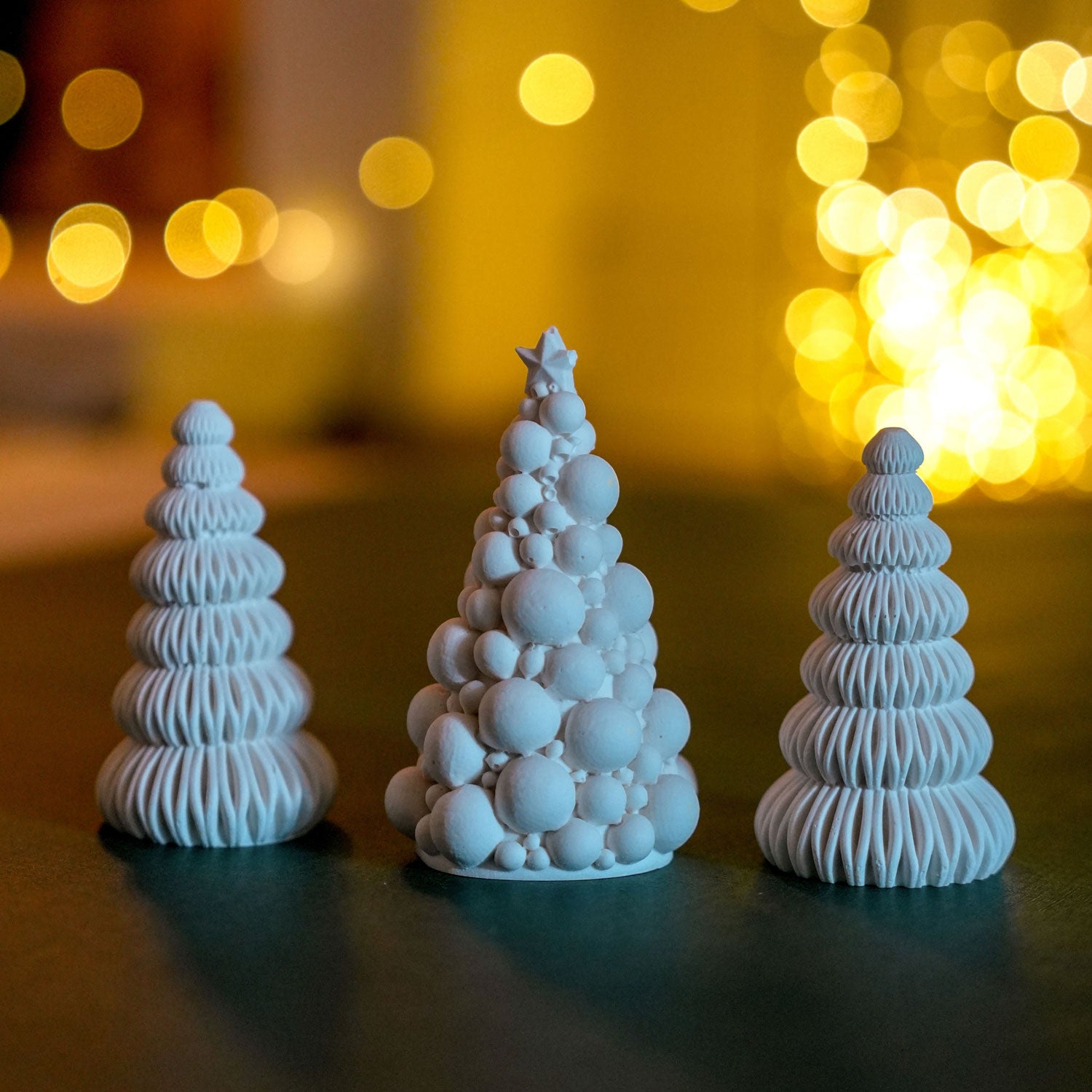 A selection of jesmonite festive trees in white.