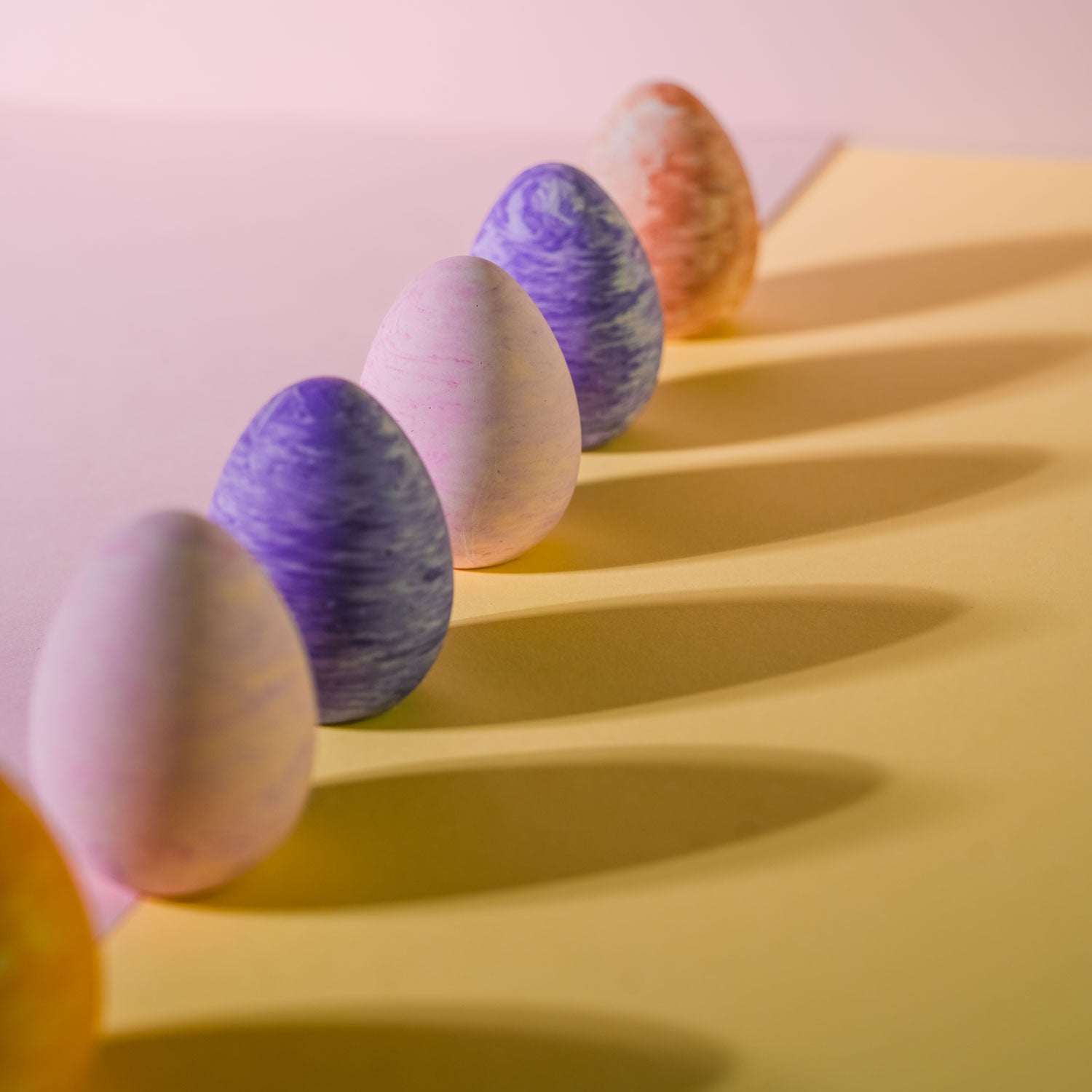 A selection of jesmonite decorative eggs in various colours