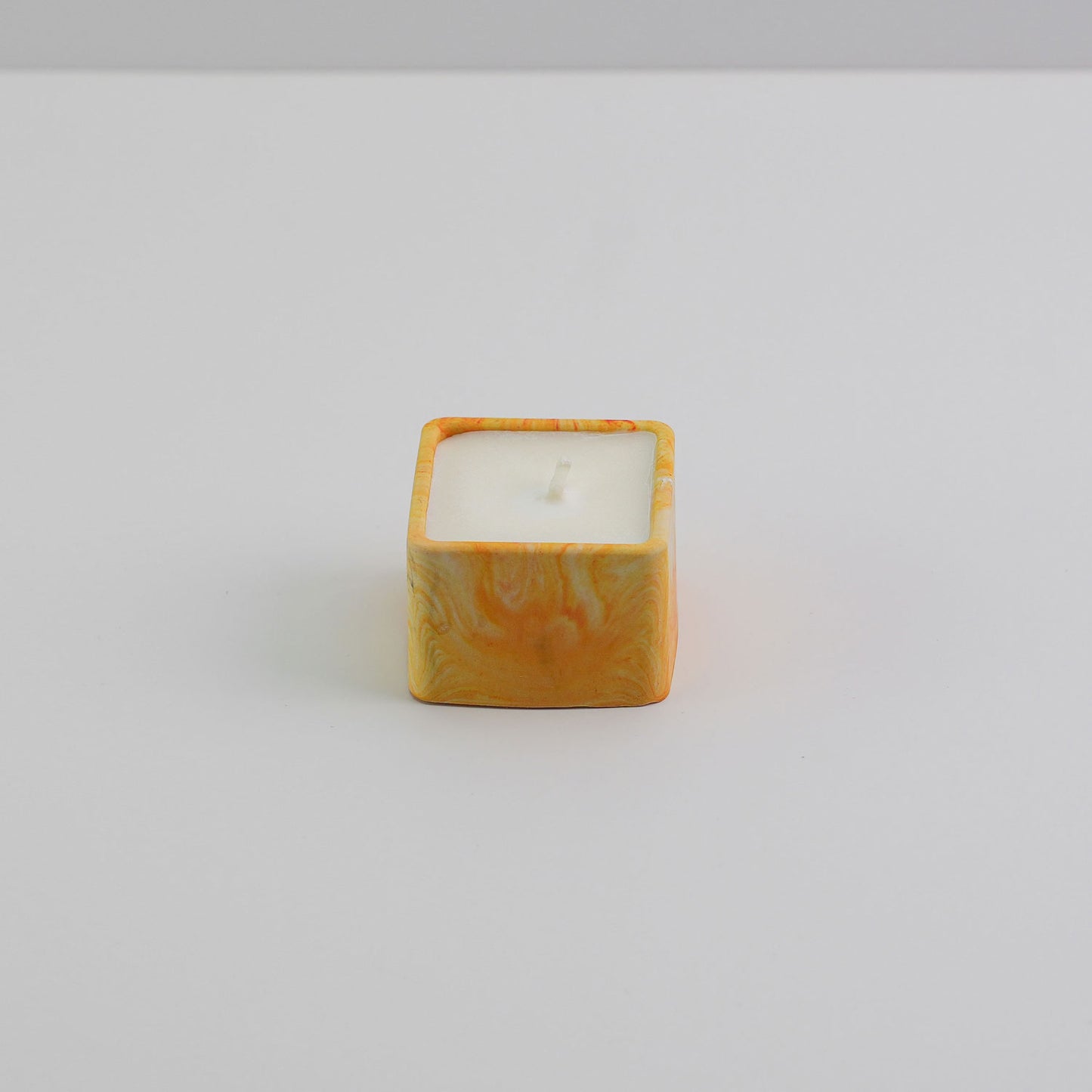  A small square jesmonite candle holder in orange