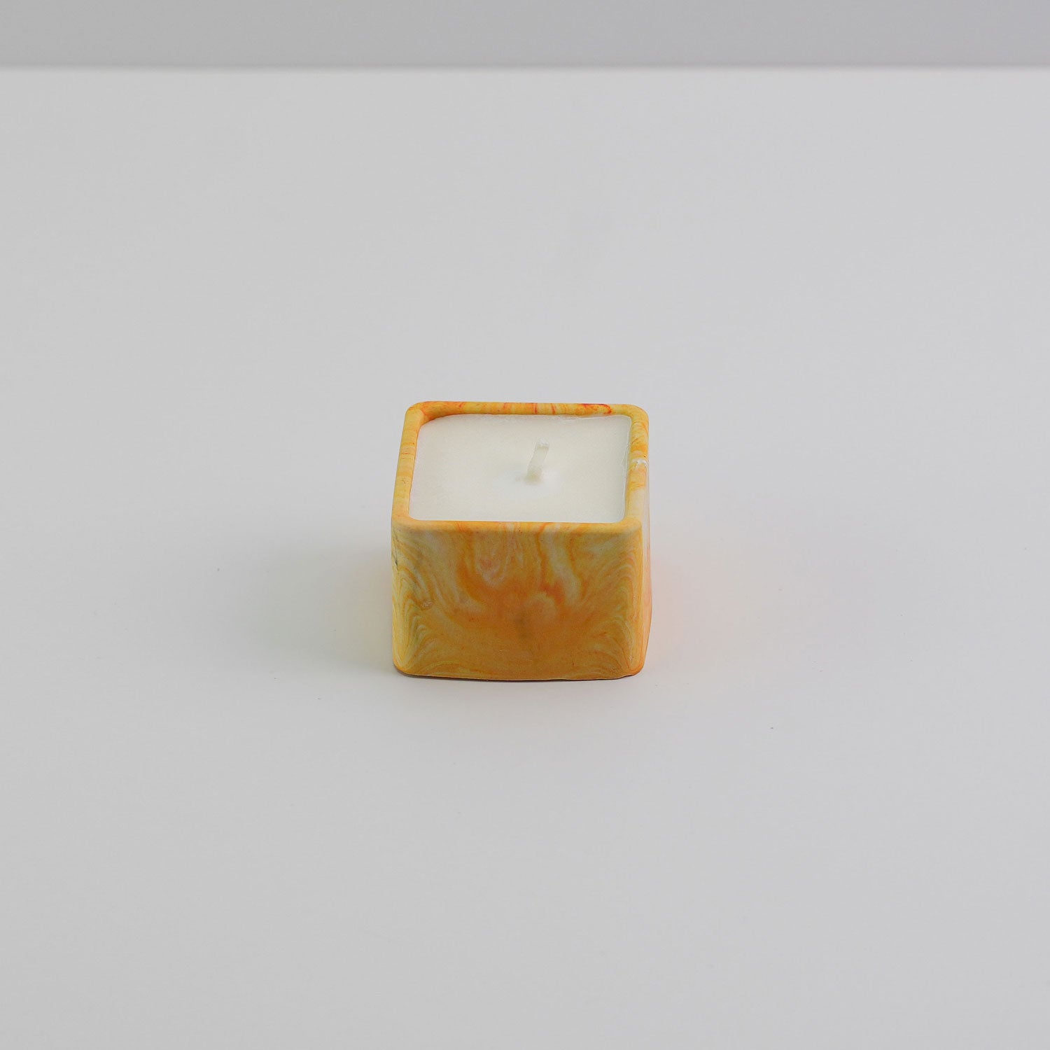  A small square jesmonite candle holder in orange