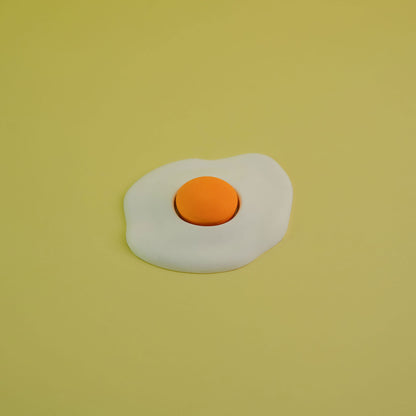 Jesmonite single yolk fried egg in yellow background