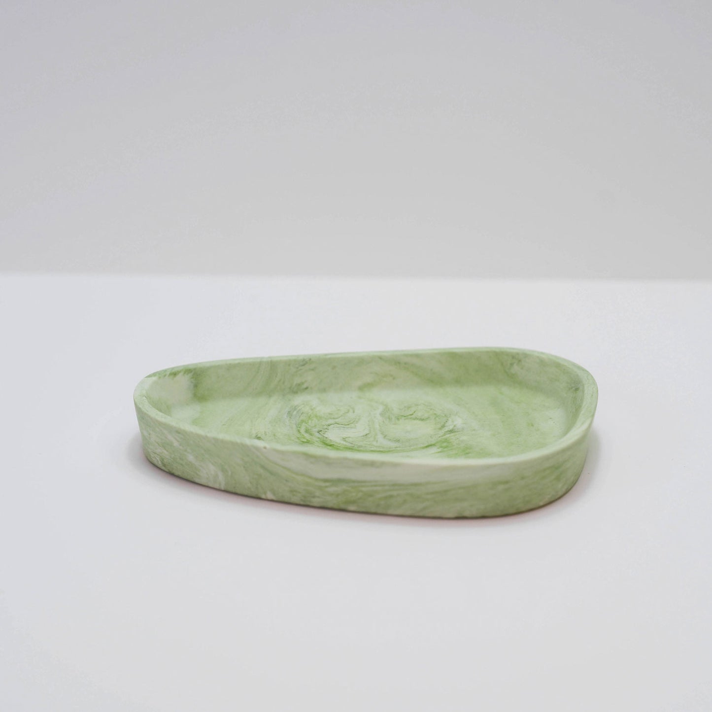 A jesmonite trinket tray in green