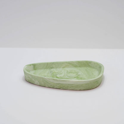 A jesmonite trinket tray in green